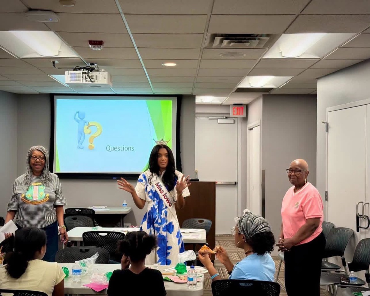 Iota Zeta Omega members with Miss Iowa at a youth workshop