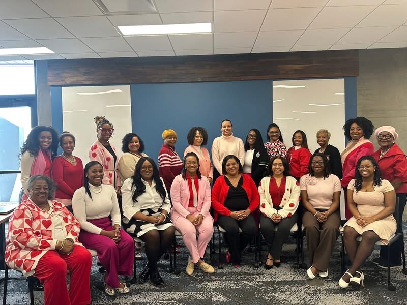 Iota Zeta Omega members together in red and pink