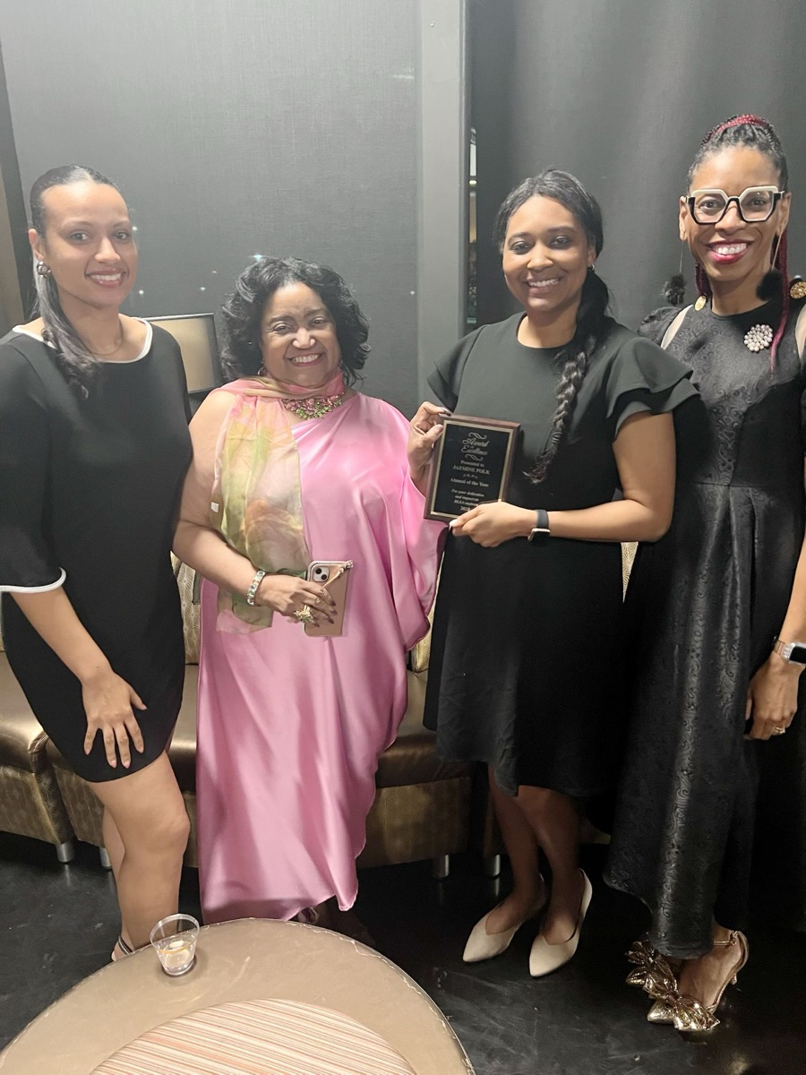 Four sorors with an Award of Excellence plaque