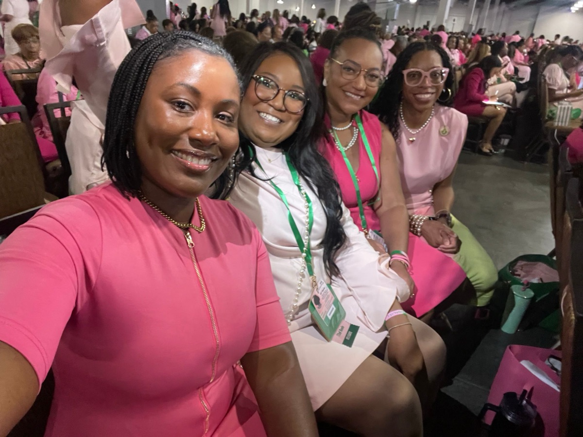 Four sorors dressed in pink at a sorority convention
