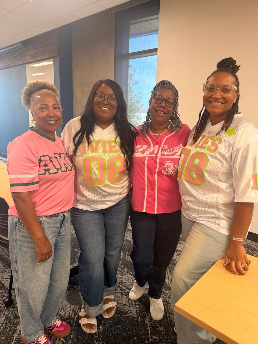 Four sorors in pink and white Ivies jerseys