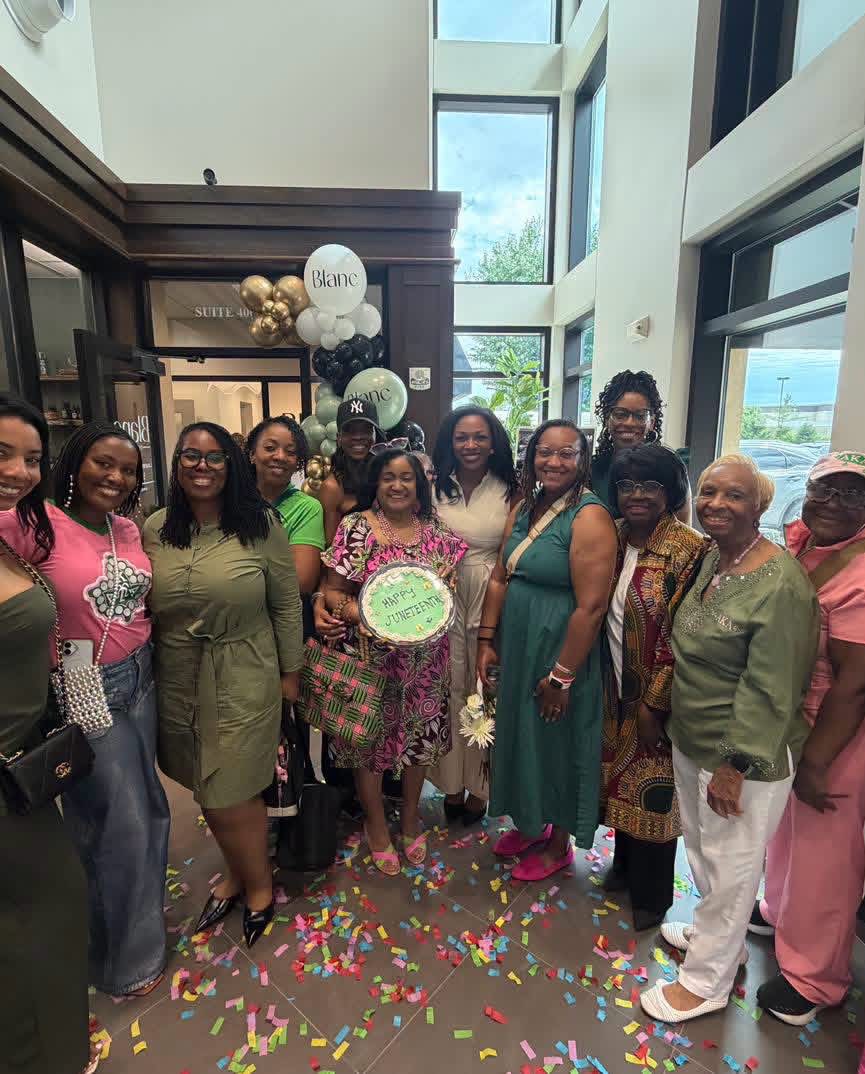 Sorors celebrating Juneteenth with a cake